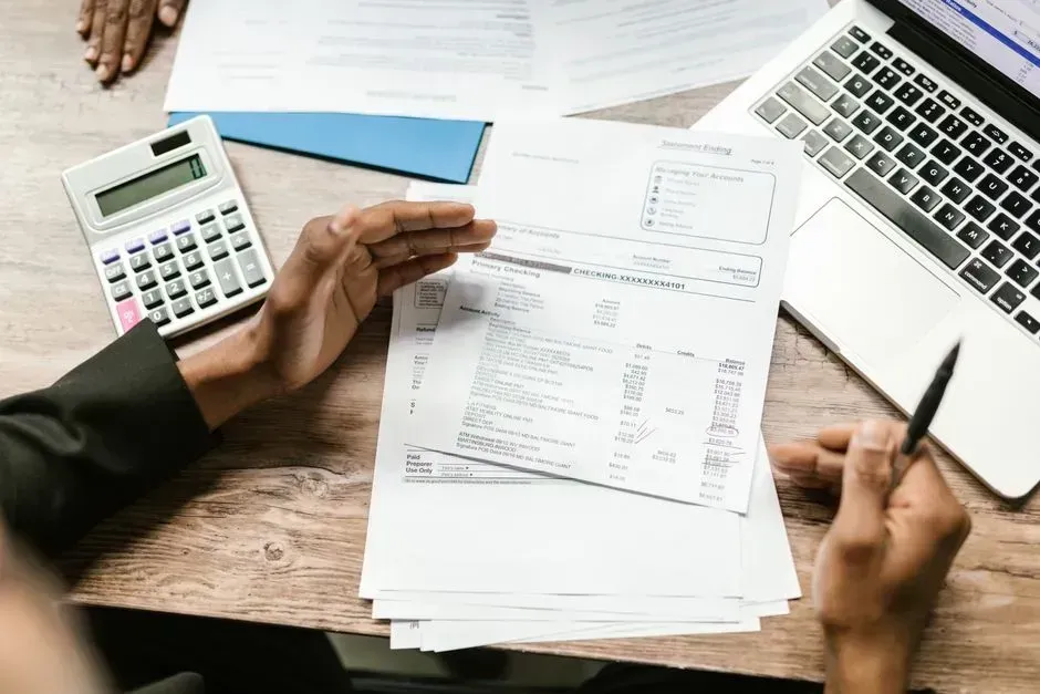 1. Writing paper checks for everyday payments (Image Credits: Pexels)