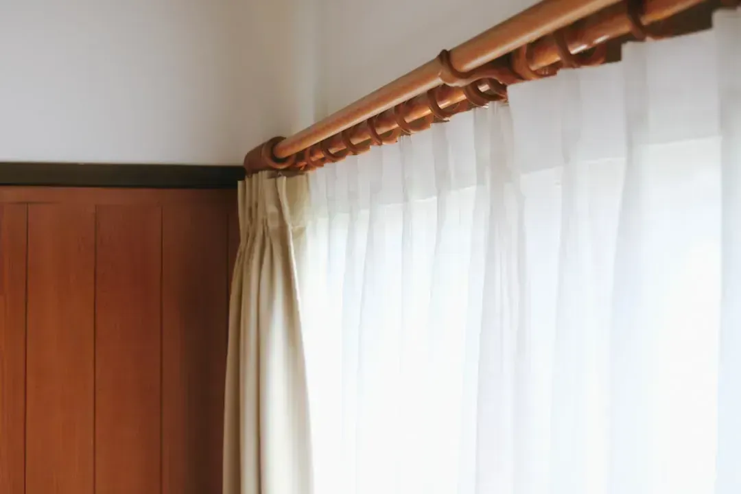 2. Hanging Curtain Rods High - and Wide (Image Credits: Unsplash)