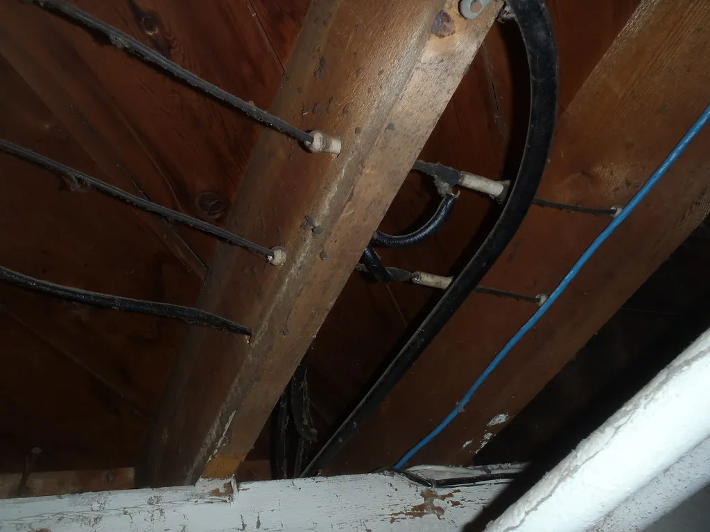 2. Knob-and-Tube Wiring Buried Under Insulation (jasonwoodhead23, Flickr, CC BY 2.0)