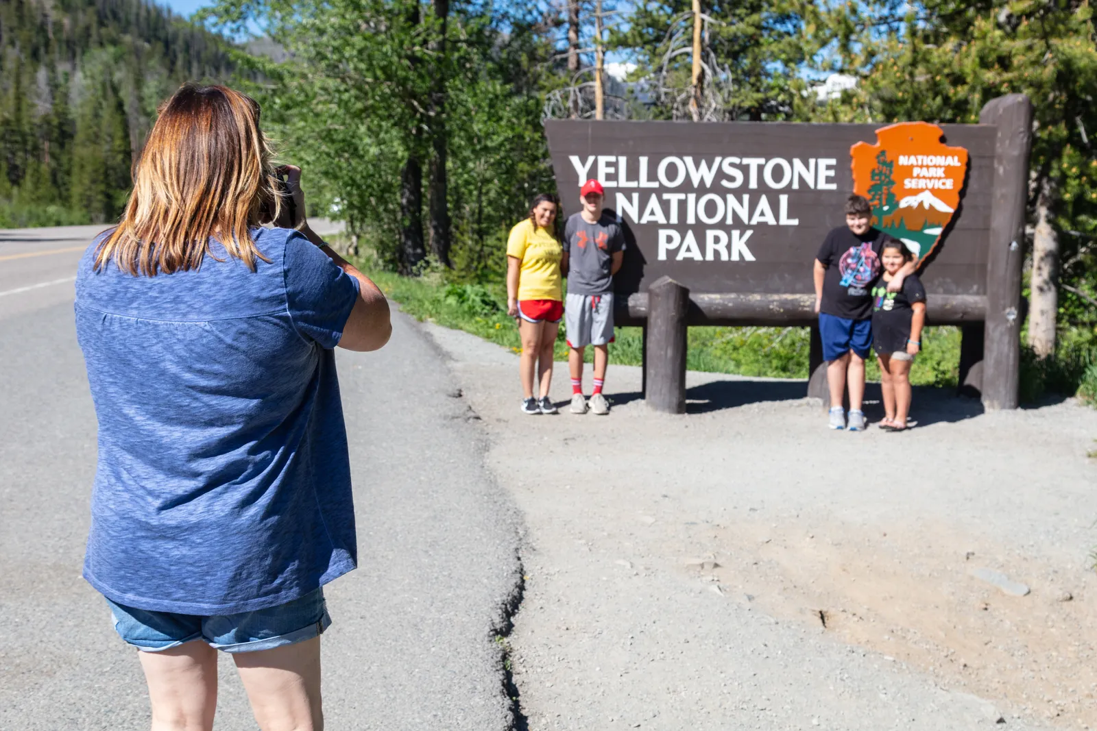 Set It Before You Walk Through the Gate (Family photo at the East Entrance park sign, Public domain)