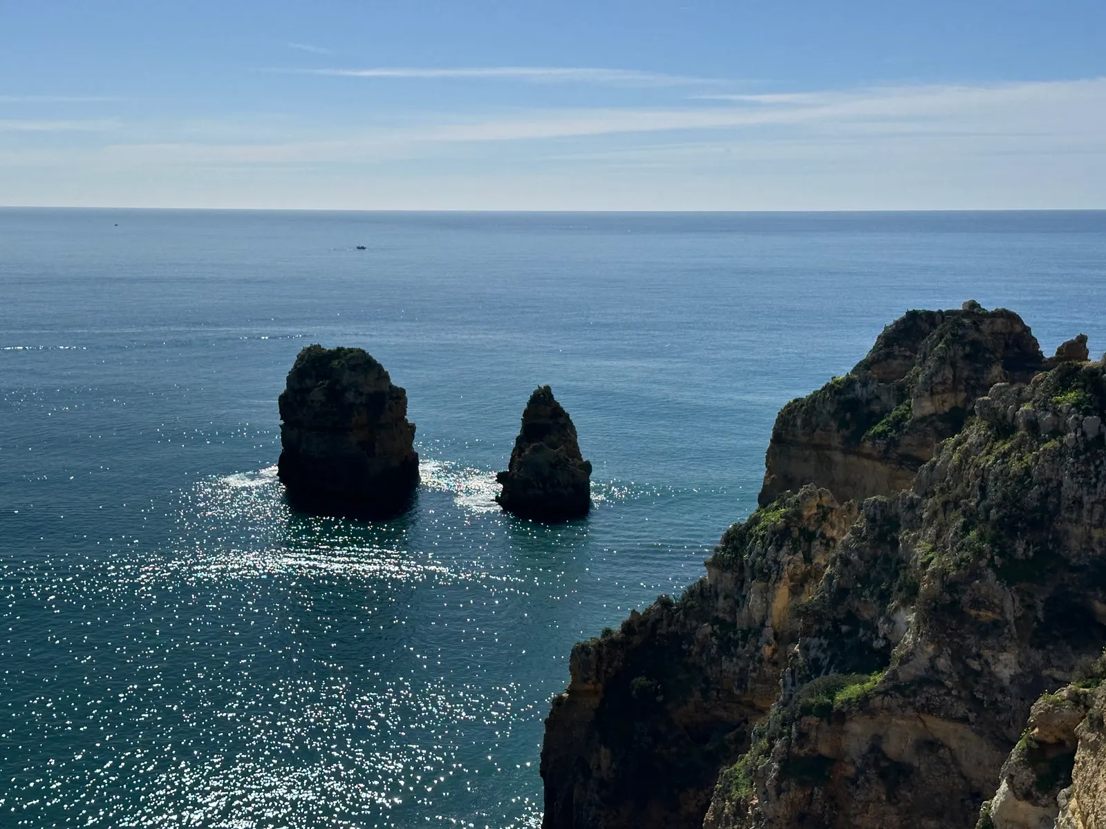 The Takeaway (Sunlit ocean with dramatic sea stacks and cliffs of Algarve near Lagos, Faro, Portugal, February 2025, CC BY 2.0)