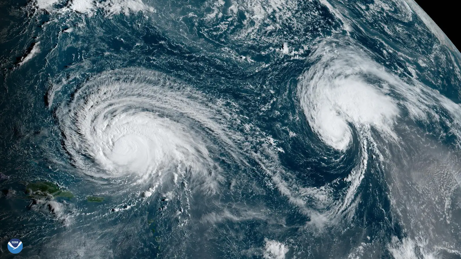 Booking Strategies and Theme Park Policies (Hurricane Lee and Tropical Storm Margot Churn Over the Atlantic, Public domain)